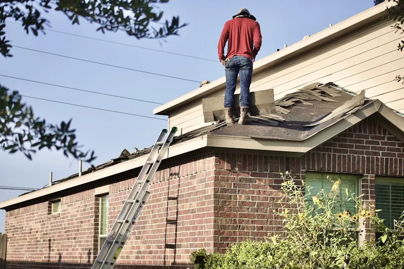 Professional roofer working on a residential roof in Willow Creek